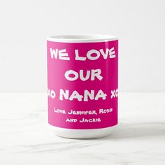 a pink coffee mug with the words we love our nana x on it