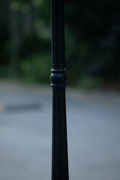 a black pole with a clock on it's side