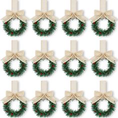 twelve christmas wreaths with bows and berries on them, all tied in burlocks