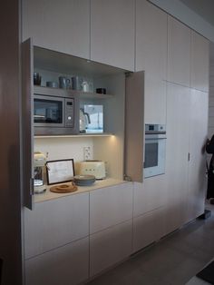 a kitchen with an oven, microwave and other items on the counter top in front of it