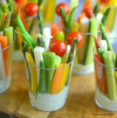 small glass cups filled with veggies and dip