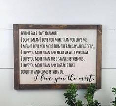 a wooden framed sign that says, i love you the most