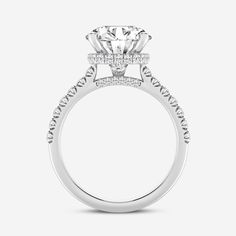 a white gold engagement ring with an oval center stone and pave set diamonds on the sides