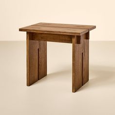 a wooden table sitting on top of a white floor