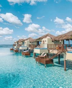 the water is crystal blue and clear with some huts on it's sides that are built into the ocean