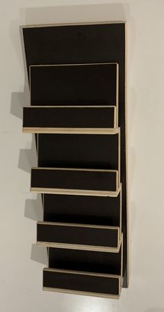 a wall mounted shelf with five shelves on it's sides and one is empty