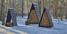 three logs stacked on top of each other in the middle of a snow covered forest