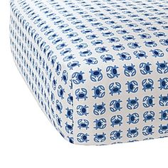 a blue and white bed sheet with an image of flowers on the bottom half of it