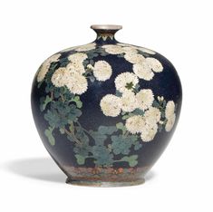 a black vase with white flowers painted on the front and sides, sitting against a white background