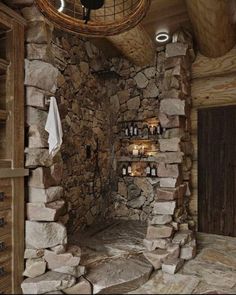 a rustic bathroom with stone walls and flooring