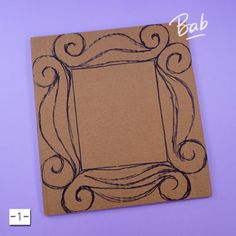 a brown card with an ornate frame drawn on the front and back side, sitting on a purple background