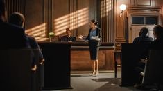 a woman standing in front of a bar talking to people