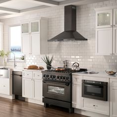 a kitchen with an oven, stove and dishwasher on the counter top in front of white cabinets