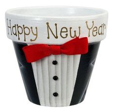 a black and white cup with a red bow tie