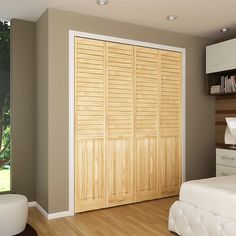 a bedroom with a bed, dresser and sliding closet doors in the middle of it