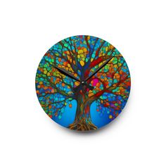 a clock with a colorful tree design on it