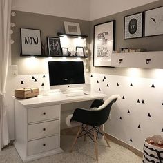 a white desk topped with a computer on top of a wooden desk next to a window