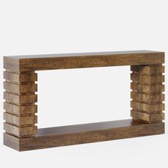 a wooden shelf with several pieces of wood stacked on top of each other in front of a white background