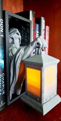 a bookend with a lantern and some books