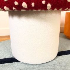 a red and white hat sitting on top of a table