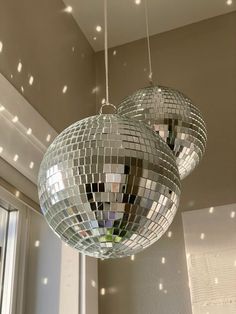 two disco ball lights hanging from a ceiling