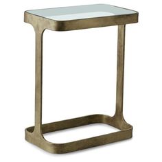 a gold metal and glass side table on a white background with no people around it