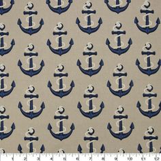 an anchor pattern on grey fabric with white and blue trim, is shown in front of a ruler