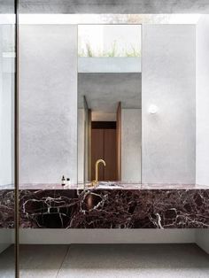 a bathroom with marble counter tops and walls