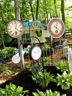 there are many clocks on display in the garden