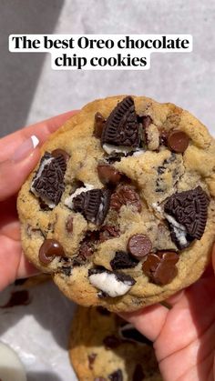 the best oreo chocolate chip cookies are in someone's hand, and they look delicious