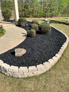 a rock garden bed in front of a house