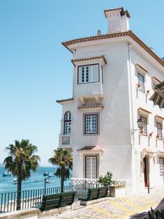 a large white building sitting next to the ocean