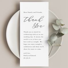 a white plate with a card that says thank you on it next to a plant