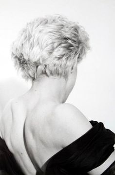 a black and white photo of a woman's back