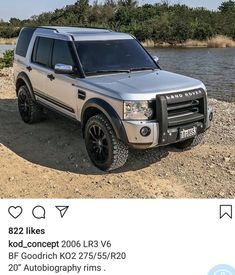 an suv parked on the side of a river