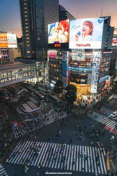 an aerial view of times square in new york city at night with people crossing the street