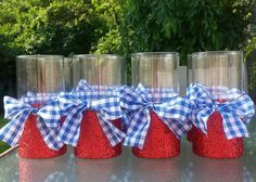 four jars with bows are sitting on a table