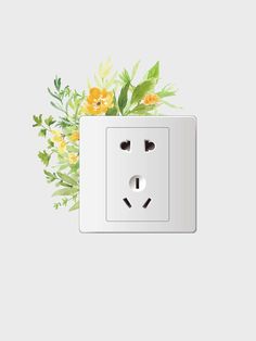 a white electrical outlet with yellow flowers on it