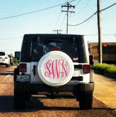 a white jeep with pink monogrammed letters on the back