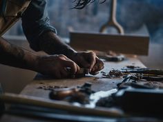 a man is working with woodworking tools on a workbench in his workshop