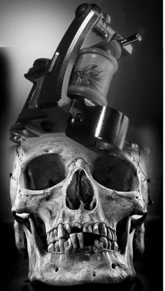 a skull with a tattoo machine on it's head