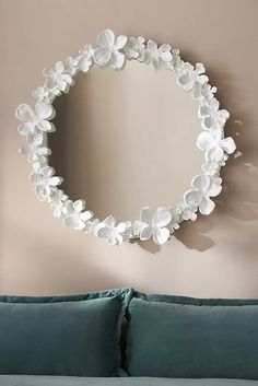 a mirror hanging on the wall above a couch