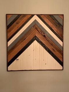 a wooden wall hanging on the side of a wall with wood strips painted on it