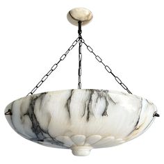 a white and black bowl hanging from a chain