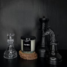 candles and chess pieces on a black table