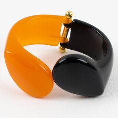 This is part of Chairish’s Costume Jewelry assortment.  Gorgeous Italian designer Angela Caputi resin clamper bracelet. A contrasting black and orange resin clamper shape with a carved geometric design. The gilded metal hardware hinge is in excellent working condition. As you know, Caputi jewelry is not signed. This is a pre-owned bracelet, and the original branded dust bag is still present. Measurements: inside across is 2.50 in wide (6.3 cm) x 2 in deep (5 cm) - width is 1.38 in wide (3.5 cm) Orange Resin, Classic Makeup, Italian Jewelry, Learning Italian, Plastic Jewelry, Black And Orange, Vintage Stuff, Italian Designer, Metal Hardware