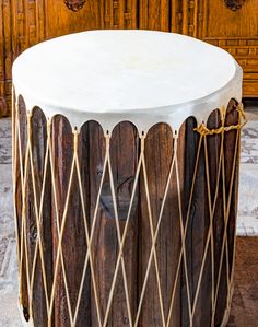 a wooden drum sitting on top of a floor