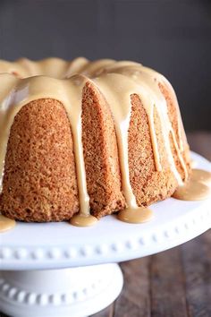 a bundt cake with icing on a white plate