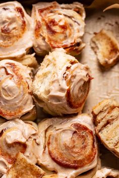 cinnamon rolls with cream cheese frosting in a baking pan