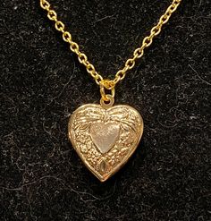 Necklace is gold in color Measures 18 inches in length Locket measures 1 inch in length and width Luxury Elegant Heart Pendant Locket Necklace, Cheap Heart Shaped Locket Jewelry, Luxury Heart Shaped Locket Necklace, Cheap Heart-shaped Locket Jewelry, Luxury Rose Gold Locket Necklace, Luxury Gold Heart Pendant Locket Necklace, Luxury Romantic Locket Necklace, Luxury Gold Locket Necklace With Heart Charm, Cottagecore Locket Necklace